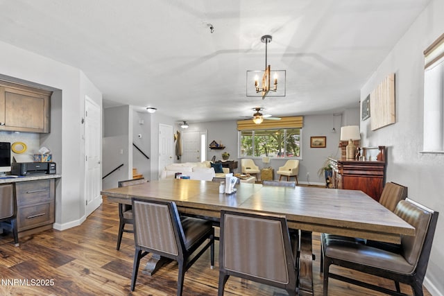 2450 Chukar Dr, Washoe Valley, NV 89704 - dining area with dark wood finished floors, stairs, a chandelier, and a ceiling fan