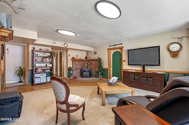 2450 Chukar Dr, Washoe Valley, NV 89704 - living room featuring a textured ceiling, wood finished floors, and a wood stove