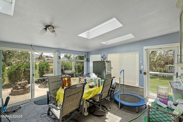 2450 Chukar Dr, Washoe Valley, NV 89704 - sunroom featuring a skylight and vaulted ceiling