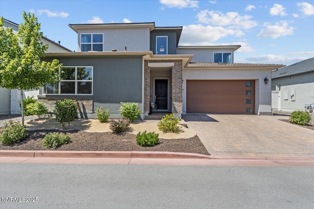 5517 Western Rider Trl, Reno, NV 89511 - view of front facade with stucco siding, an attached garage, and decorative driveway