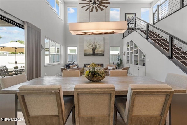 5517 Western Rider Trl, Reno, NV 89511 - dining area with a towering ceiling, a fireplace, and healthy amount of natural light