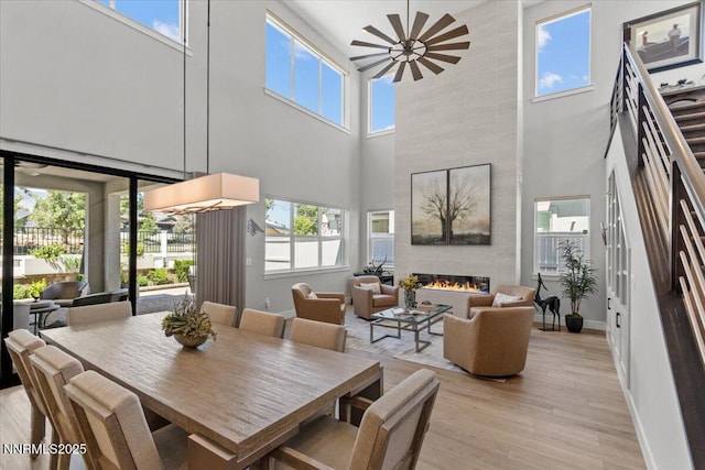 5517 Western Rider Trl, Reno, NV 89511 - dining space with a towering ceiling, light wood finished floors, and a tiled fireplace