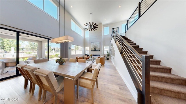 5517 Western Rider Trl, Reno, NV 89511 - dining area featuring stairway, light wood-style flooring, a towering ceiling, recessed lighting, and a ceiling fan