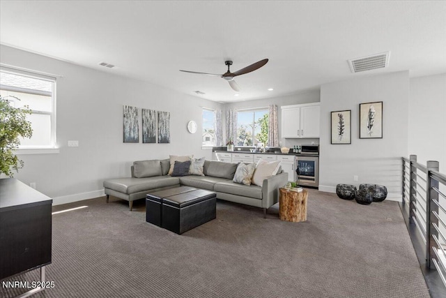 5517 Western Rider Trl, Reno, NV 89511 - living room featuring wine cooler, carpet floors, and ceiling fan