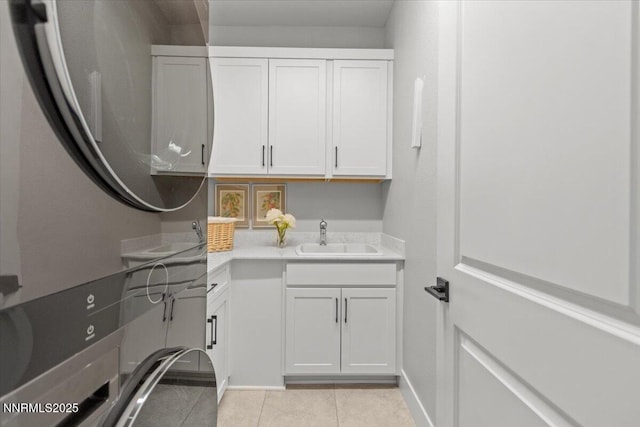 5517 Western Rider Trl, Reno, NV 89511 - laundry area featuring cabinet space, stacked washer and clothes dryer, and light tile patterned floors