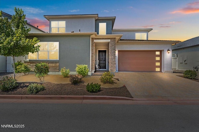 5517 Western Rider Trl, Reno, NV 89511 - view of front facade with stucco siding, an attached garage, and decorative driveway