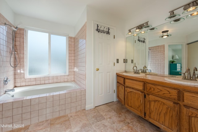 653 Carmel Way, Gardnerville, NV 89460 - full bathroom with tiled bath, double vanity, and tile patterned flooring
