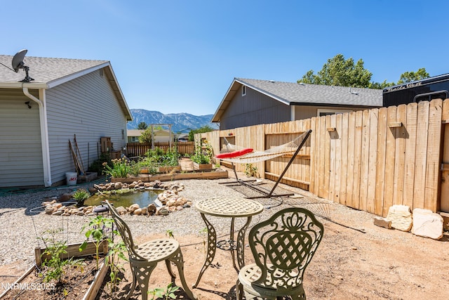 653 Carmel Way, Gardnerville, NV 89460 - fenced backyard with a mountain view, a vegetable garden, and a patio area
