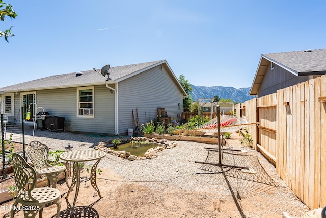 653 Carmel Way, Gardnerville, NV 89460 - back of property with a mountain view, a patio area, and a small pond