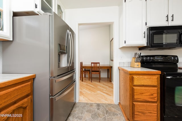 653 Carmel Way, Gardnerville, NV 89460 - kitchen featuring black appliances, tile counters, white cabinets, and light stone finish flooring