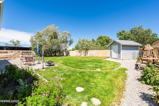 653 Carmel Way, Gardnerville, NV 89460 - fenced backyard with a fire pit, a storage unit, and a patio