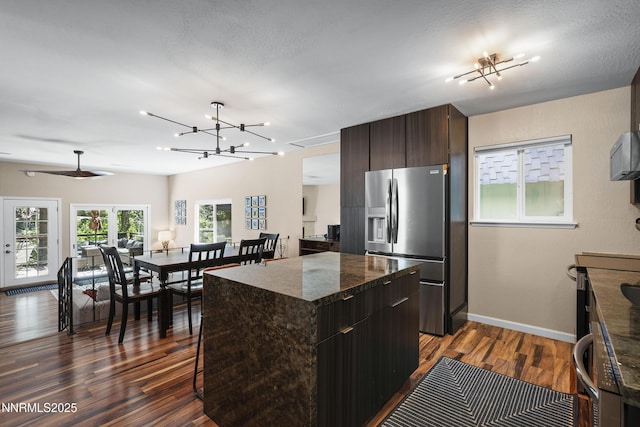 978 Glenrock Dr Unit 36, Incline Village, NV 89451 - kitchen with appliances with stainless steel finishes, dark wood-style floors, a center island, dark brown cabinetry, and a chandelier