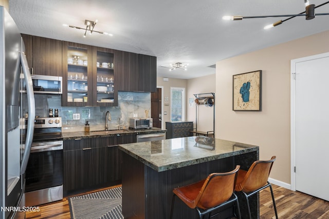 978 Glenrock Dr Unit 36, Incline Village, NV 89451 - kitchen featuring appliances with stainless steel finishes, modern cabinets, dark wood-style floors, and tasteful backsplash
