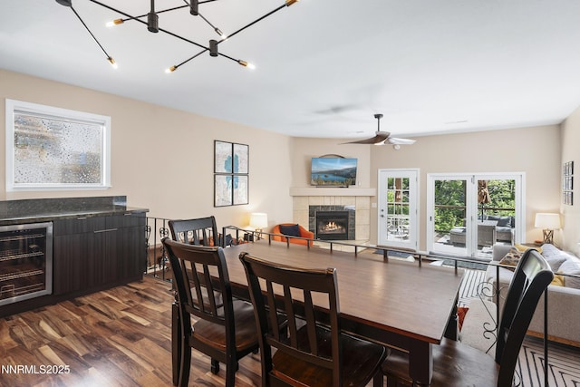 978 Glenrock Dr Unit 36, Incline Village, NV 89451 - dining space with beverage cooler, a fireplace, dark wood-style flooring, ceiling fan, and a chandelier