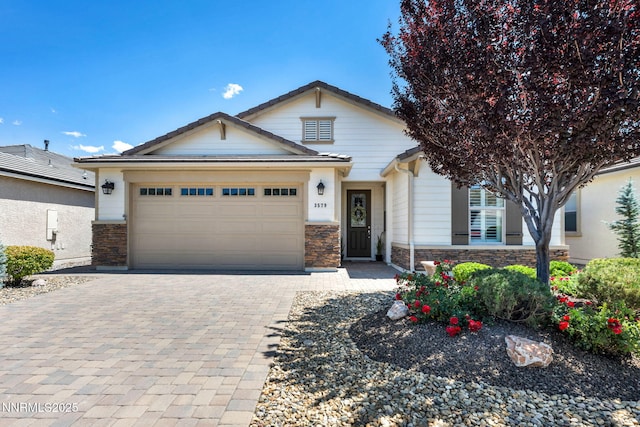 3579 Long Dr, Minden, NV 89423 - view of front of home with stone siding, a garage, and decorative driveway