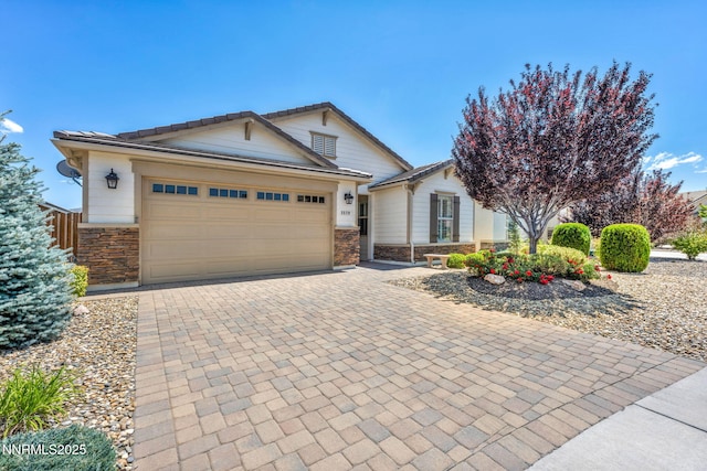 3579 Long Dr, Minden, NV 89423 - view of front facade featuring stone siding, decorative driveway, and an attached garage