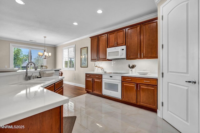 3579 Long Dr, Minden, NV 89423 - kitchen with white appliances, crown molding, light countertops, brown cabinets, and a chandelier
