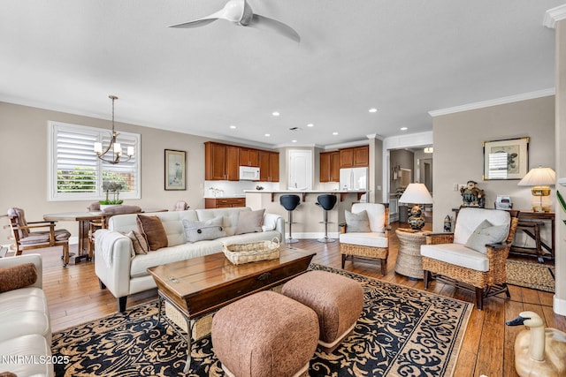 3579 Long Dr, Minden, NV 89423 - living area with crown molding, light wood-style floors, recessed lighting, a ceiling fan, and a chandelier
