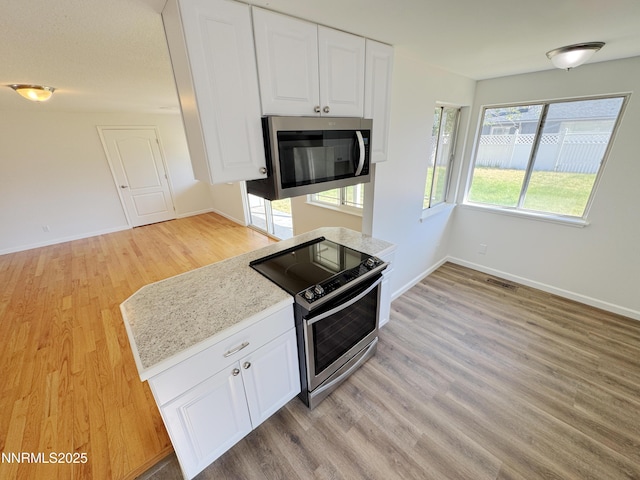1568 County Rd, Minden, NV 89423 - kitchen featuring stainless steel appliances, light wood-style flooring, and white cabinetry