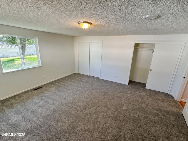 1568 County Rd, Minden, NV 89423 - unfurnished bedroom with carpet, two closets, and a textured ceiling