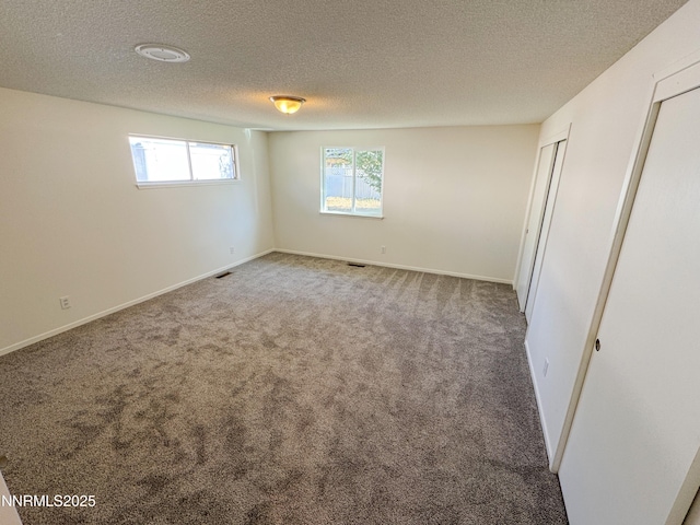 1568 County Rd, Minden, NV 89423 - unfurnished bedroom featuring carpet, a textured ceiling, and multiple closets