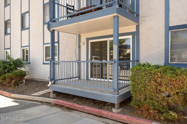 2555 Clear Acre Ln Apt 13, Reno, NV 89512 - property entrance featuring stucco siding, a balcony, and covered porch