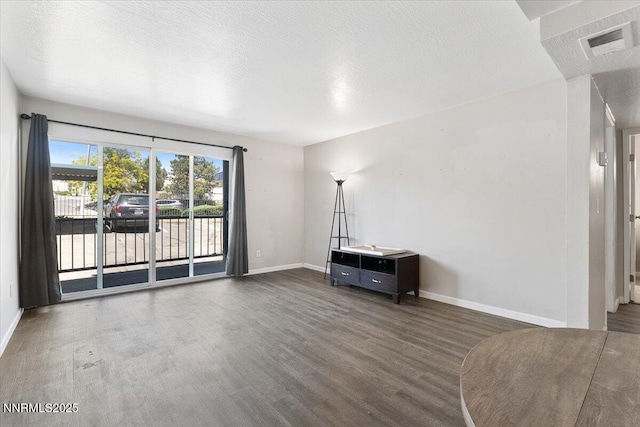 2555 Clear Acre Ln Apt 13, Reno, NV 89512 - unfurnished living room featuring wood finished floors and a textured ceiling