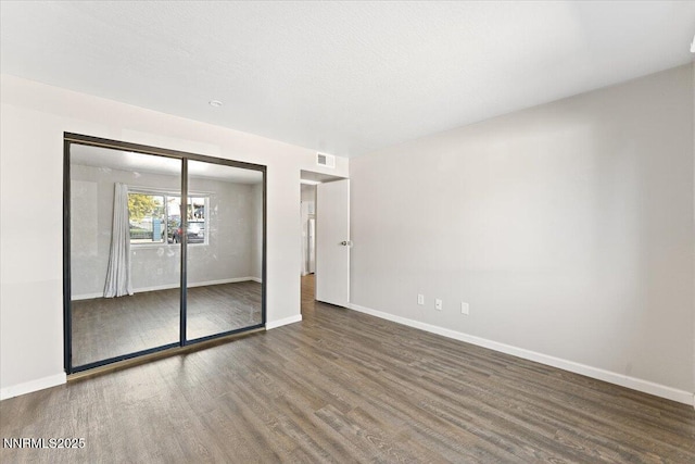 2555 Clear Acre Ln Apt 13, Reno, NV 89512 - unfurnished bedroom featuring wood finished floors and a closet