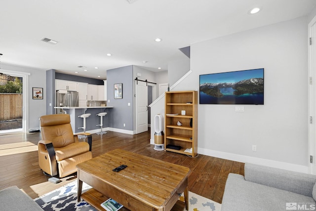 1585 Foster Dr, Reno, NV 89509 - living room featuring a barn door, dark wood finished floors, and recessed lighting