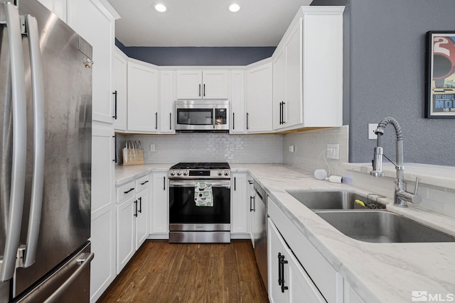 1585 Foster Dr, Reno, NV 89509 - kitchen featuring stainless steel appliances, recessed lighting, white cabinetry, backsplash, and dark wood finished floors