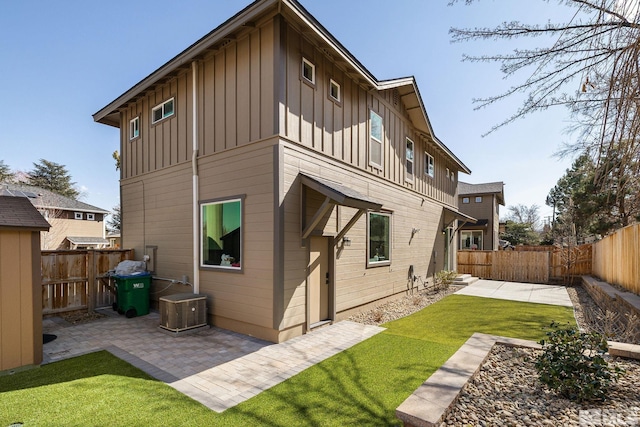 1585 Foster Dr, Reno, NV 89509 - rear view of property with board and batten siding, a patio area, and a fenced backyard