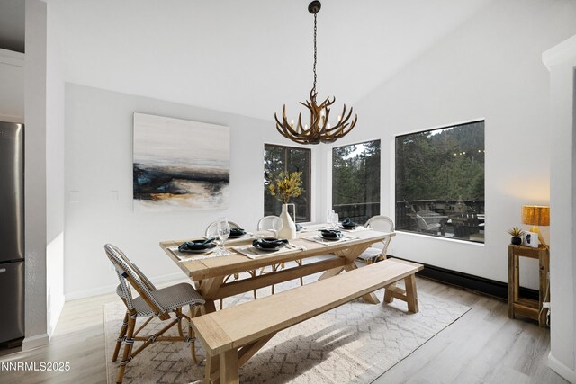 960 Apollo Way, Incline Village, NV 89451 - dining area featuring a chandelier, wood finished floors, and vaulted ceiling