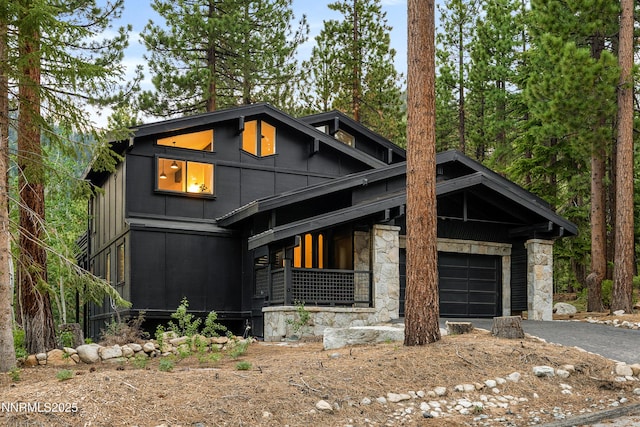 960 Apollo Way, Incline Village, NV 89451 - contemporary home with stone siding, asphalt driveway, and a garage