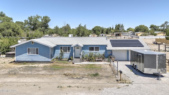 3480 York Ln, Fallon, NV 89406 - single story home featuring an attached garage, roof mounted solar panels, roof with shingles, a chimney, and driveway