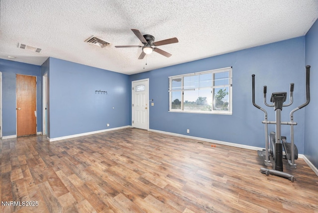 3480 York Ln, Fallon, NV 89406 - unfurnished living room featuring ceiling fan, wood finished floors, and a textured ceiling