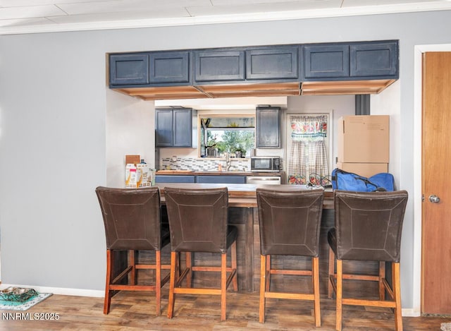 3480 York Ln, Fallon, NV 89406 - bar area with appliances with stainless steel finishes, crown molding, and wood finished floors