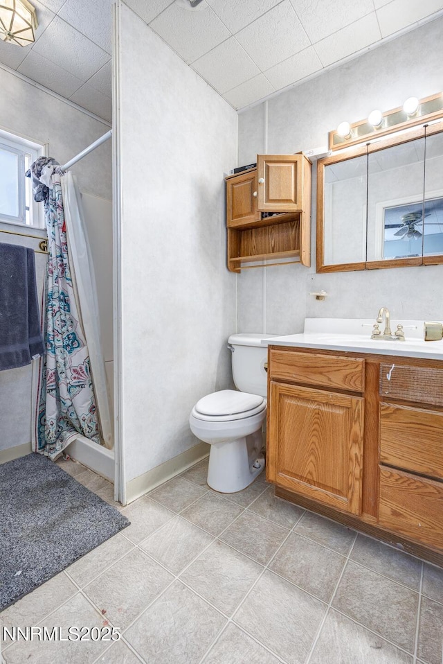 3480 York Ln, Fallon, NV 89406 - bathroom with vanity, a shower with curtain, a paneled ceiling, a ceiling fan, and tile patterned flooring