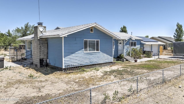 3480 York Ln, Fallon, NV 89406 - ranch-style house with entry steps, a fenced backyard, and a chimney