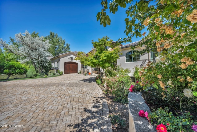 3820 Frost Ln, Reno, NV 89511 - mediterranean / spanish house with a garage, stucco siding, decorative driveway, and a tile roof