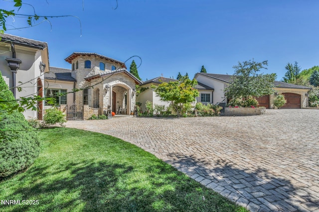 3820 Frost Ln, Reno, NV 89511 - mediterranean / spanish-style home featuring decorative driveway, stucco siding, stone siding, a garage, and a gate