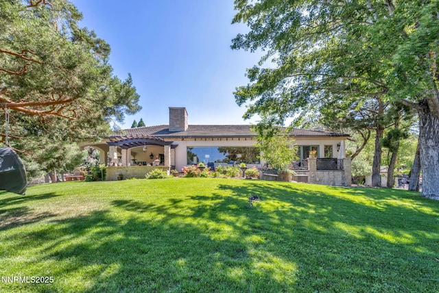 3820 Frost Ln, Reno, NV 89511 - back of property with a chimney, a pergola, a yard, stone siding, and stucco siding