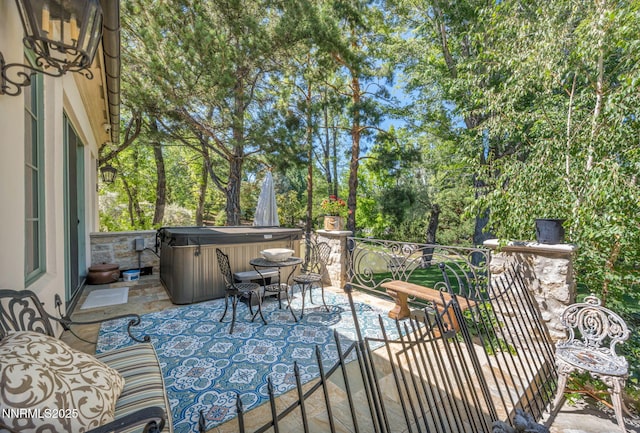 3820 Frost Ln, Reno, NV 89511 - view of patio / terrace with a hot tub and view of wooded area