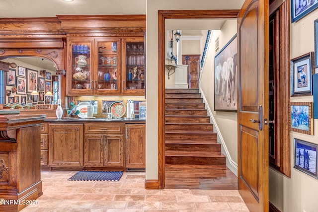 3820 Frost Ln, Reno, NV 89511 - bar featuring stairs, stone finish floors, and ornamental molding
