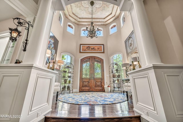 3820 Frost Ln, Reno, NV 89511 - entryway featuring decorative columns, a chandelier, plenty of natural light, a towering ceiling, and french doors