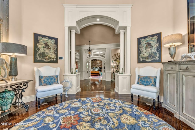 3820 Frost Ln, Reno, NV 89511 - sitting room with ornate columns, arched walkways, dark wood finished floors, and a high ceiling
