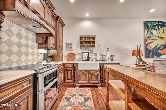 3820 Frost Ln, Reno, NV 89511 - kitchen featuring range with two ovens, custom range hood, light countertops, recessed lighting, and decorative backsplash