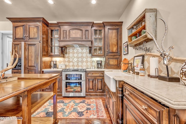 3820 Frost Ln, Reno, NV 89511 - bar featuring stainless steel range oven, decorative backsplash, recessed lighting, and paneled built in refrigerator