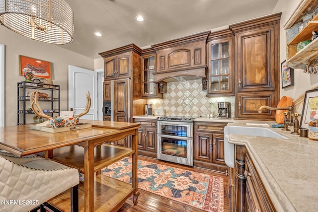 3820 Frost Ln, Reno, NV 89511 - kitchen with light countertops, range with two ovens, backsplash, recessed lighting, and brown cabinetry