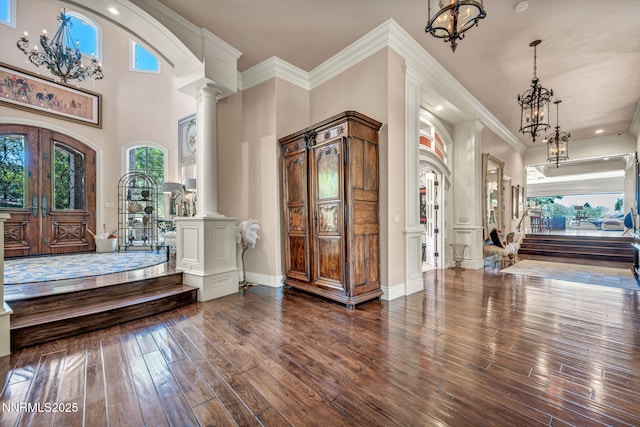 3820 Frost Ln, Reno, NV 89511 - entrance foyer with decorative columns, a chandelier, dark wood finished floors, ornamental molding, and recessed lighting