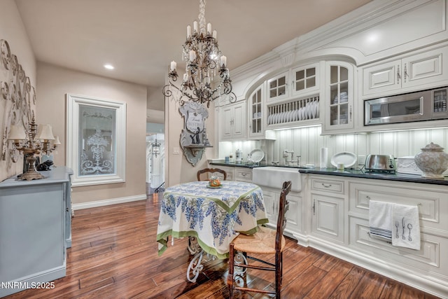 3820 Frost Ln, Reno, NV 89511 - dining area featuring dark wood finished floors, a chandelier, and recessed lighting